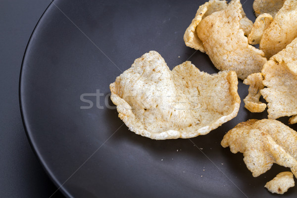 Fish crisp rice cracker on black plate Stock photo © supersaiyan3