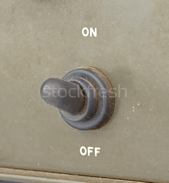 Stock photo: old black toggle switch on green surface - on