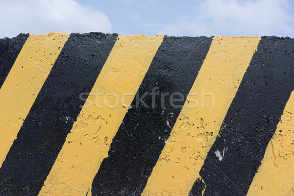 Yellow and black concrete barrier Stock photo © Supertrooper