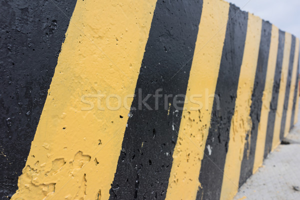 Yellow and black concrete barrier Stock photo © Supertrooper