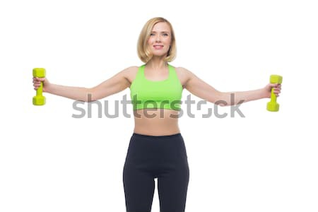 Beautiful woman doing sport exercise with dumbbells Stock photo © svetography