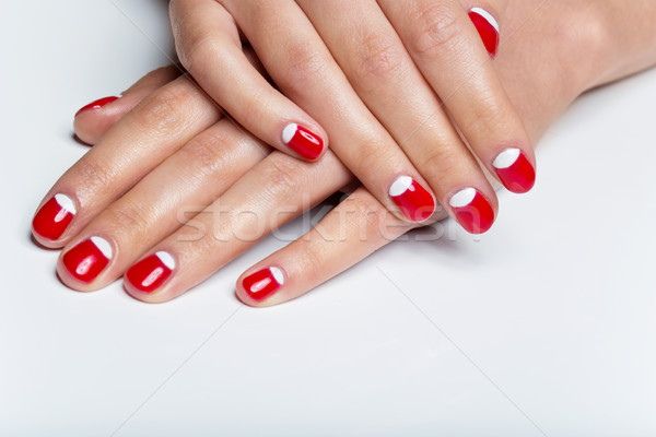 Female hands with red and white nails Stock photo © svetography