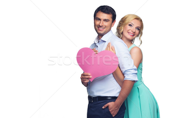 Stock photo: Beautiful couple holding pink heart