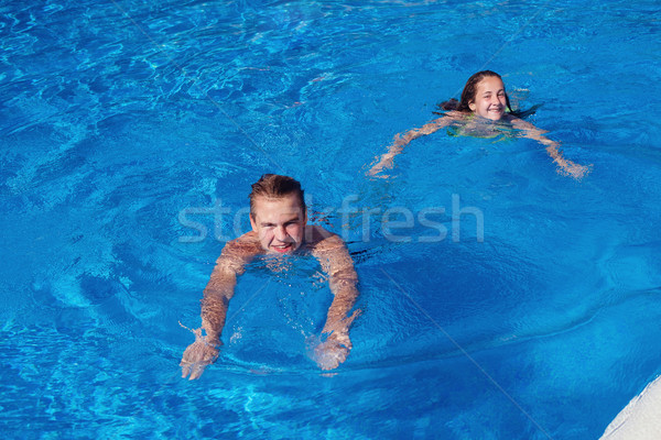 boy and girl having fun in swimming pool Stock photo © svetography