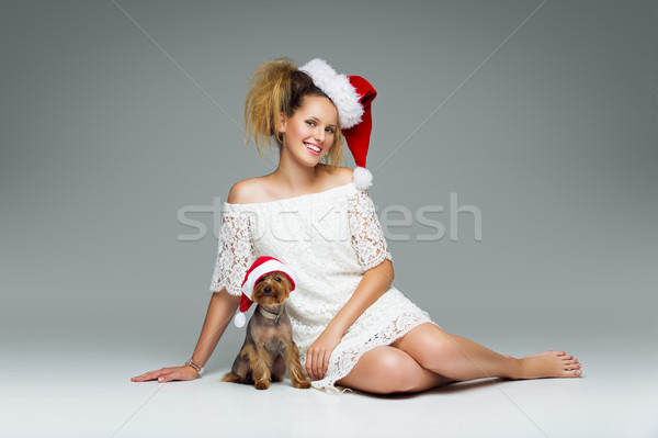 Beautiful girl with yorkie dog in santa cap Stock photo © svetography