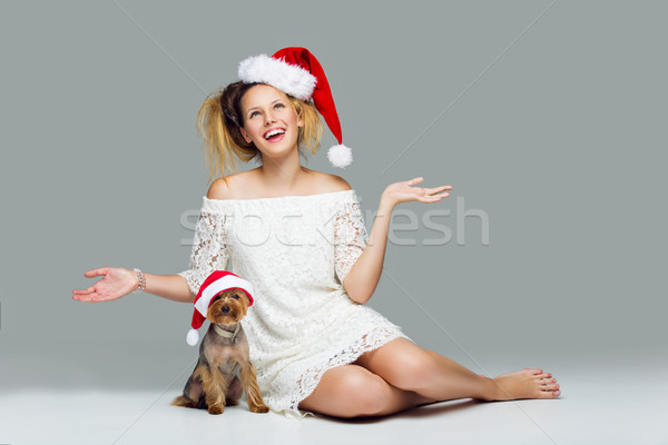 Beautiful girl with yorkie dog in santa cap Stock photo © svetography