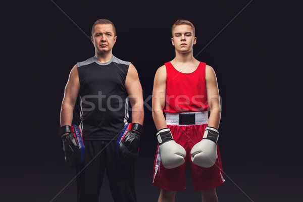 Young boxer working out with coach Stock photo © svetography