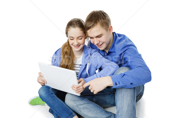 Teen boy and girl sitting with tablets Stock photo © svetography