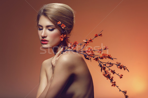 Beautiful girl with sakura branch Stock photo © svetography