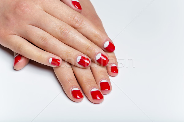 Female hands with red and white nails Stock photo © svetography