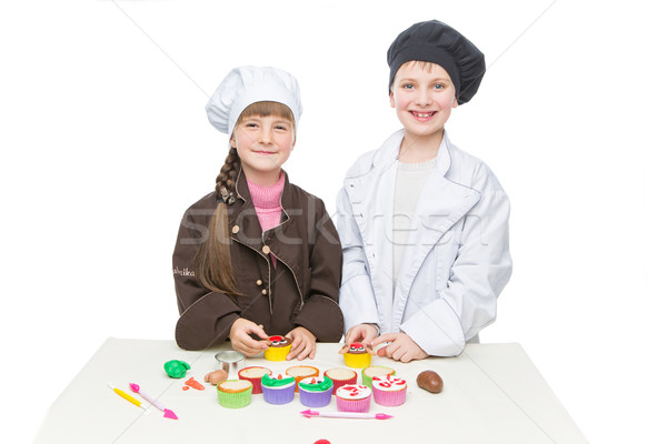 Stock photo: Children making christmas cupcakes