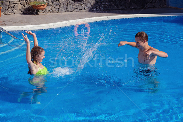 boy and girl having fun in swimming pool Stock photo © svetography