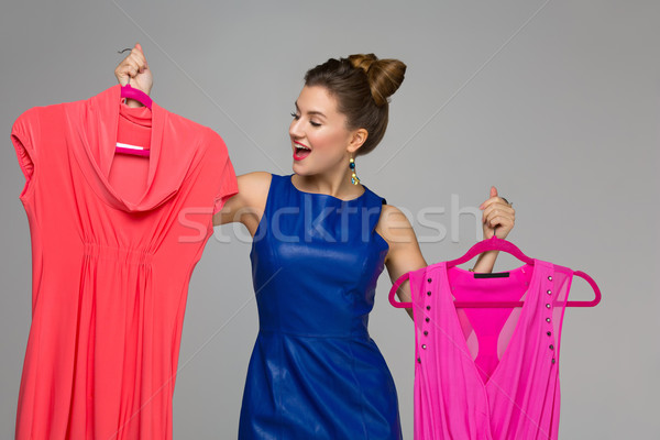 Happy girl with dresses Stock photo © svetography