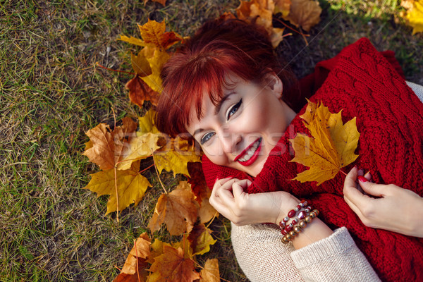 Red hair girl lying with autumn maple leaf Stock photo © svetography