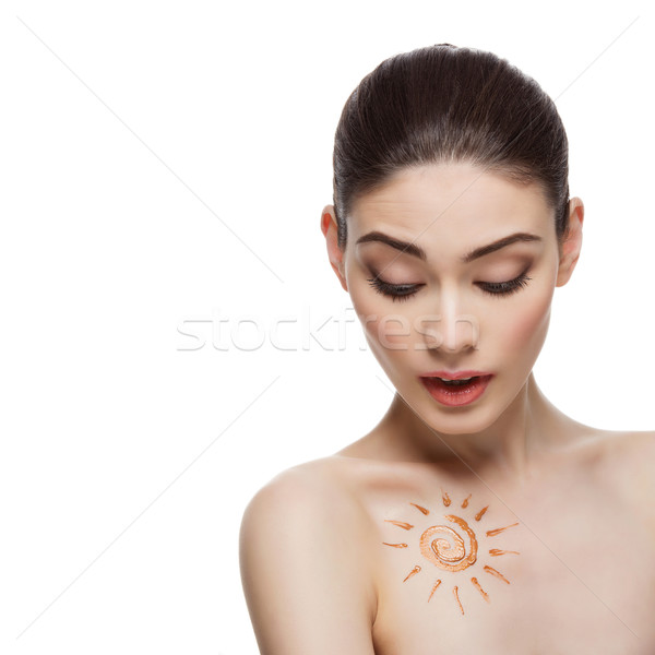 Girl with cream sun shape drawing on chest Stock photo © svetography