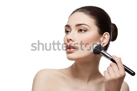 Beautiful girl applying powder with brush Stock photo © svetography