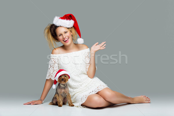 Beautiful girl with yorkie dog in santa cap Stock photo © svetography
