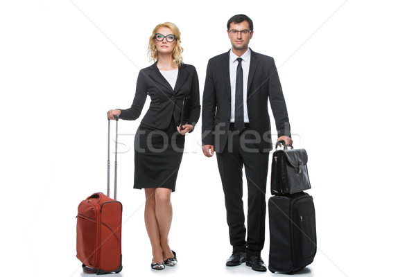 Businessman and business woman with travel cases Stock photo © svetography