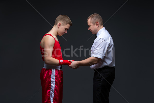 Stock photo: Referee checking young boxer