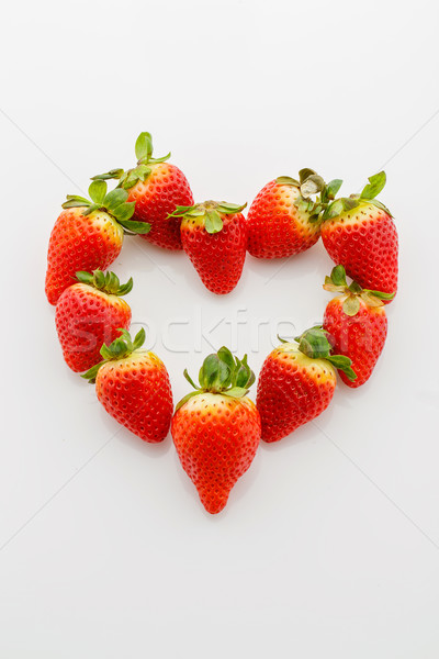 Closeup of fresh strawberries in heart shape Stock photo © svetography