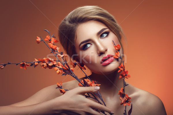 Beautiful girl with sakura branch Stock photo © svetography