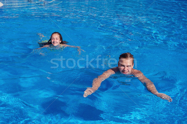 boy and girl having fun in swimming pool Stock photo © svetography