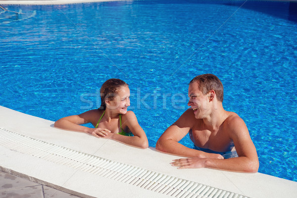 boy and girl having fun in swimming pool Stock photo © svetography