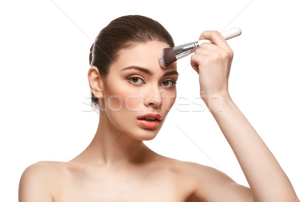girl applying foundation on face isolated on white Stock photo © svetography