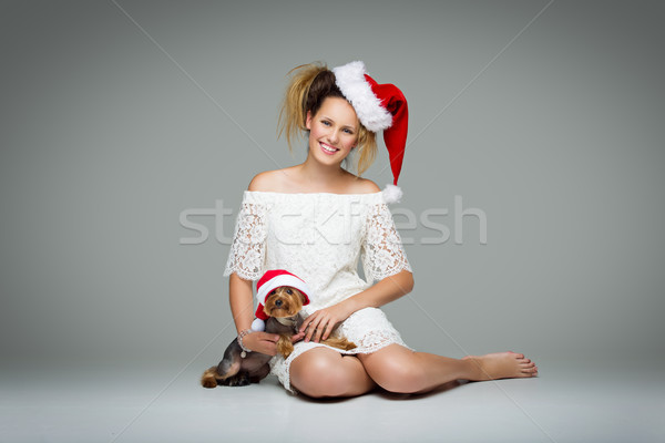 Beautiful girl with yorkie dog in santa cap Stock photo © svetography