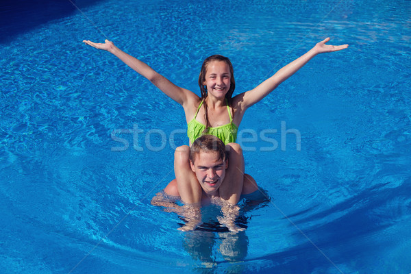 boy and girl having fun in swimming pool Stock photo © svetography