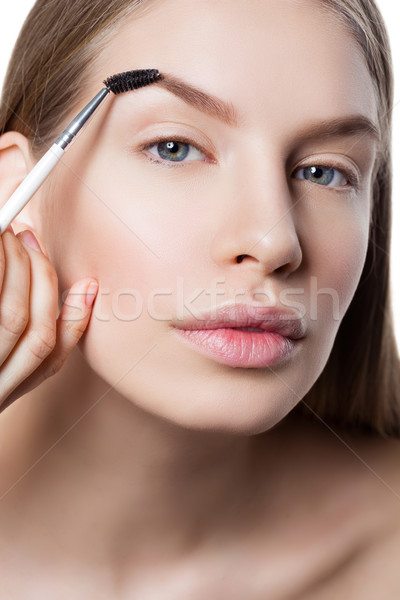 Woman correcting eyebrows form Stock photo © svetography