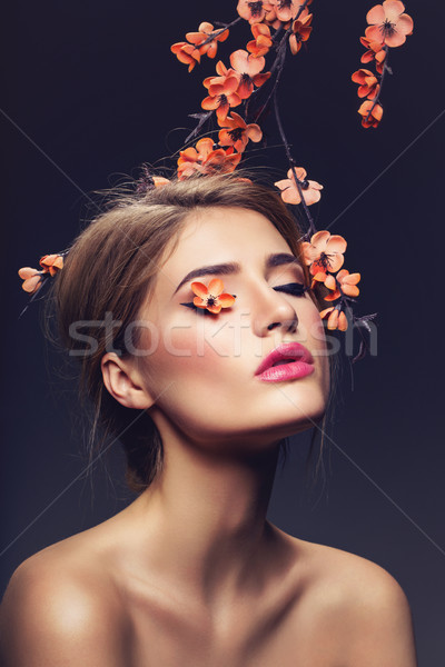 Beautiful girl with sakura branch Stock photo © svetography