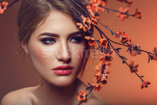 Beautiful girl with sakura branch Stock photo © svetography