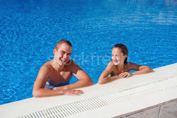 boy and girl having fun in swimming pool Stock photo © svetography