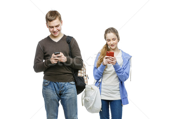 Teen boy and girl standing with mobile phones Stock photo © svetography