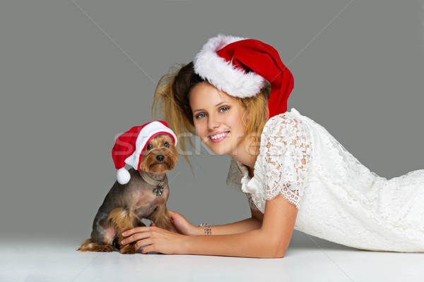 Beautiful girl with yorkie dog in santa cap Stock photo © svetography