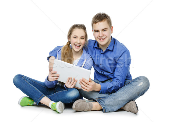 Teen boy and girl sitting with tablets Stock photo © svetography