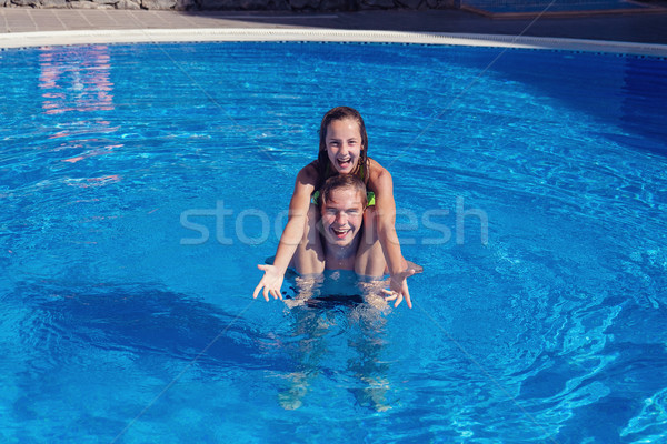 boy and girl having fun in swimming pool Stock photo © svetography