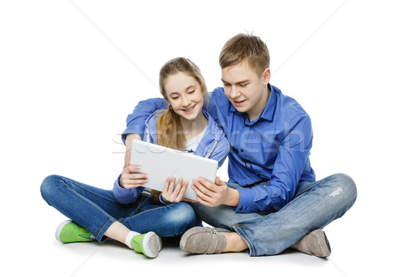 Teen age boy and girl with tablet Stock photo © svetography