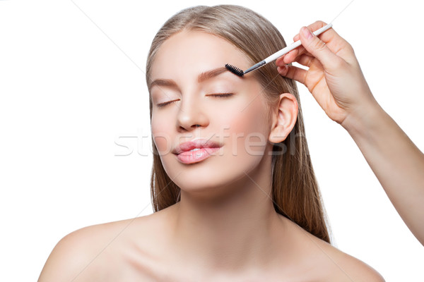 Woman correcting eyebrows form Stock photo © svetography