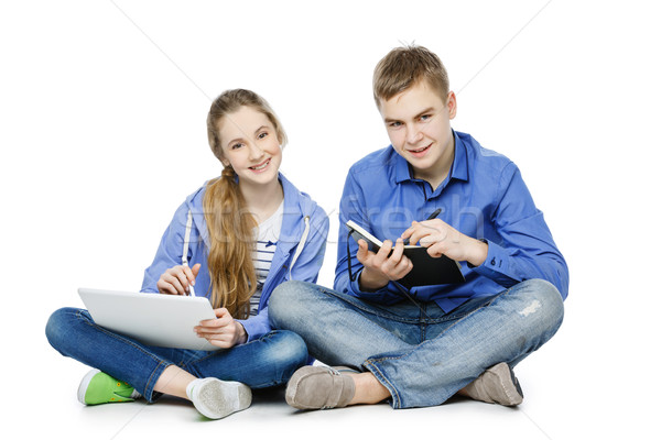 Teen age boy and girl with tablet and notebook Stock photo © svetography