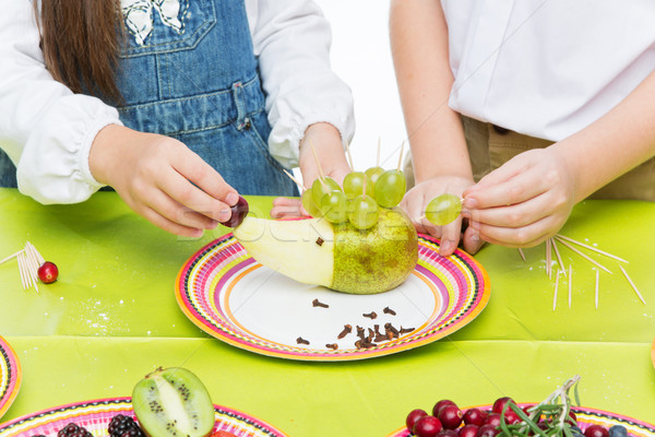 Children making fruit hedgehog Stock photo © svetography