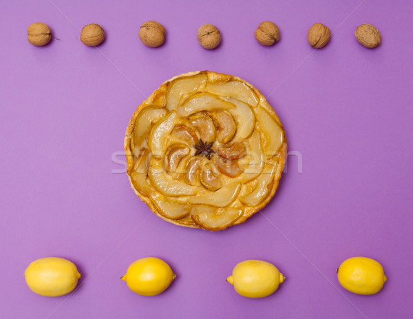 Tarte Tatin apple pear tart with fruits on purple background Stock photo © szabiphotography