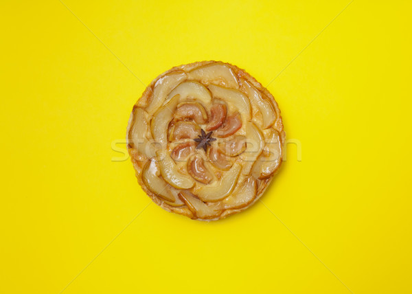 Whole tarte Tatin apple pear tart isolated on yellow background Stock photo © szabiphotography