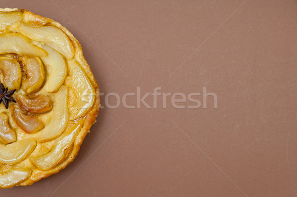 Whole tarte Tatin apple pear tart isolated on brown background Stock photo © szabiphotography