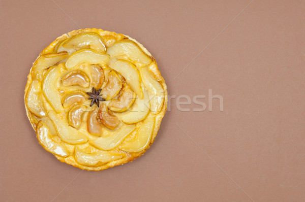 Whole tarte Tatin apple pear tart isolated on brown background Stock photo © szabiphotography