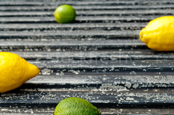 Raw textured black  Background backdrop with lemon and lime  Stock photo © szabiphotography