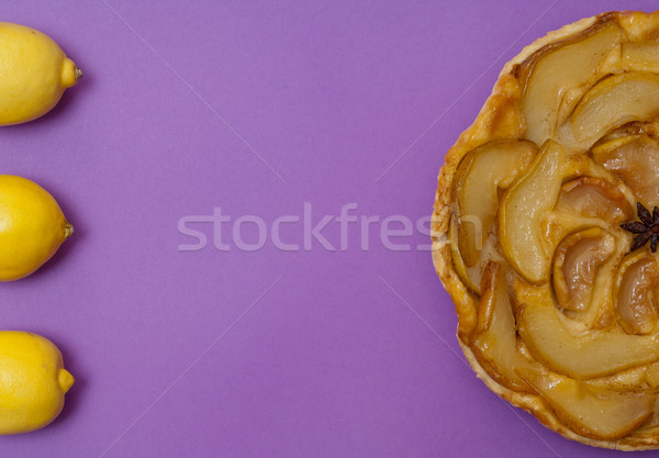 Tarte Tatin apple pear tart and lemons on purple background Stock photo © szabiphotography