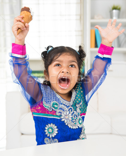 Happy girl eating ice cream.  Stock photo © szefei