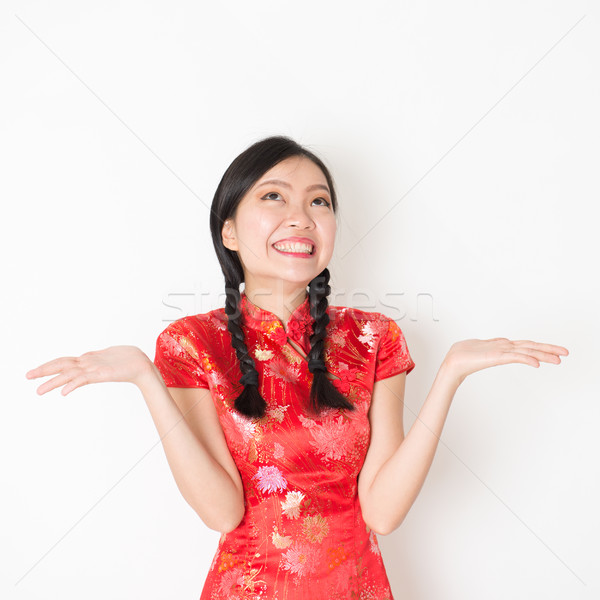 Surprised oriental woman in red qipao  Stock photo © szefei